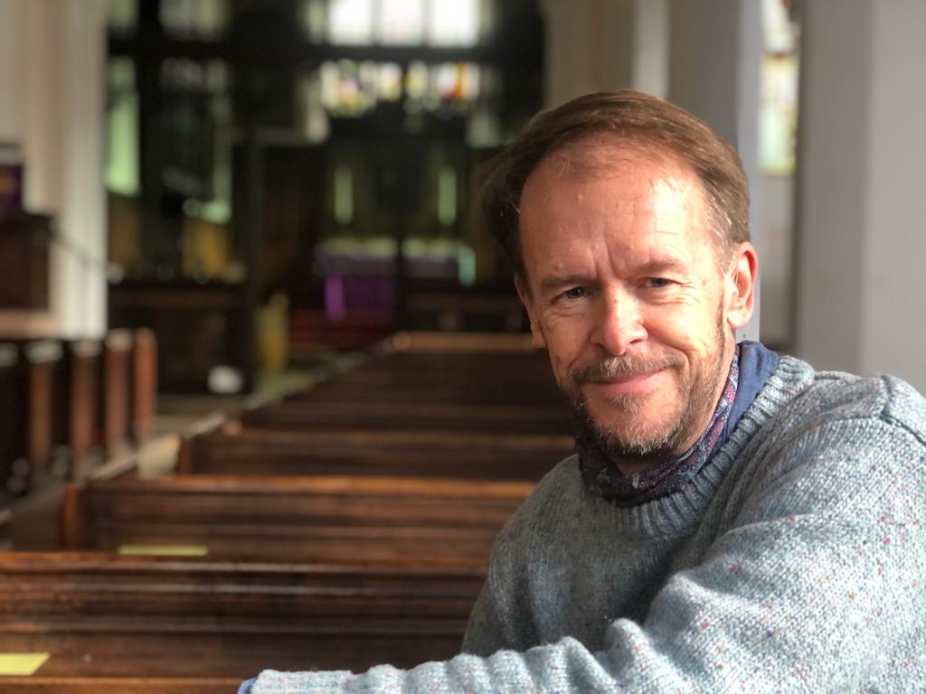 Portrait of Roland Robertson in the pews of St Botolph's